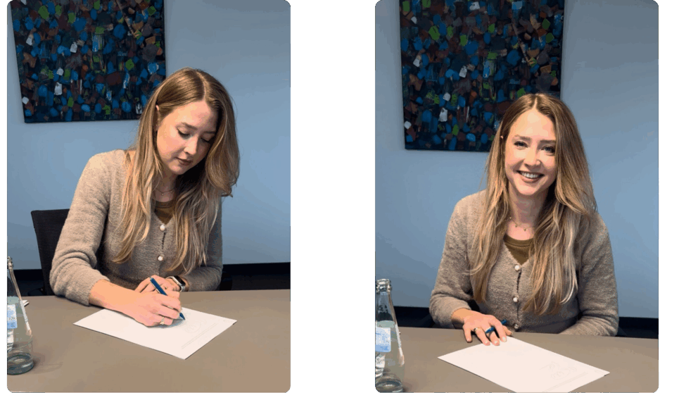 Frau unterschreibt einen Notarvertrag – Symbolbild für den Immobilienkauf als Kapitalanlage.